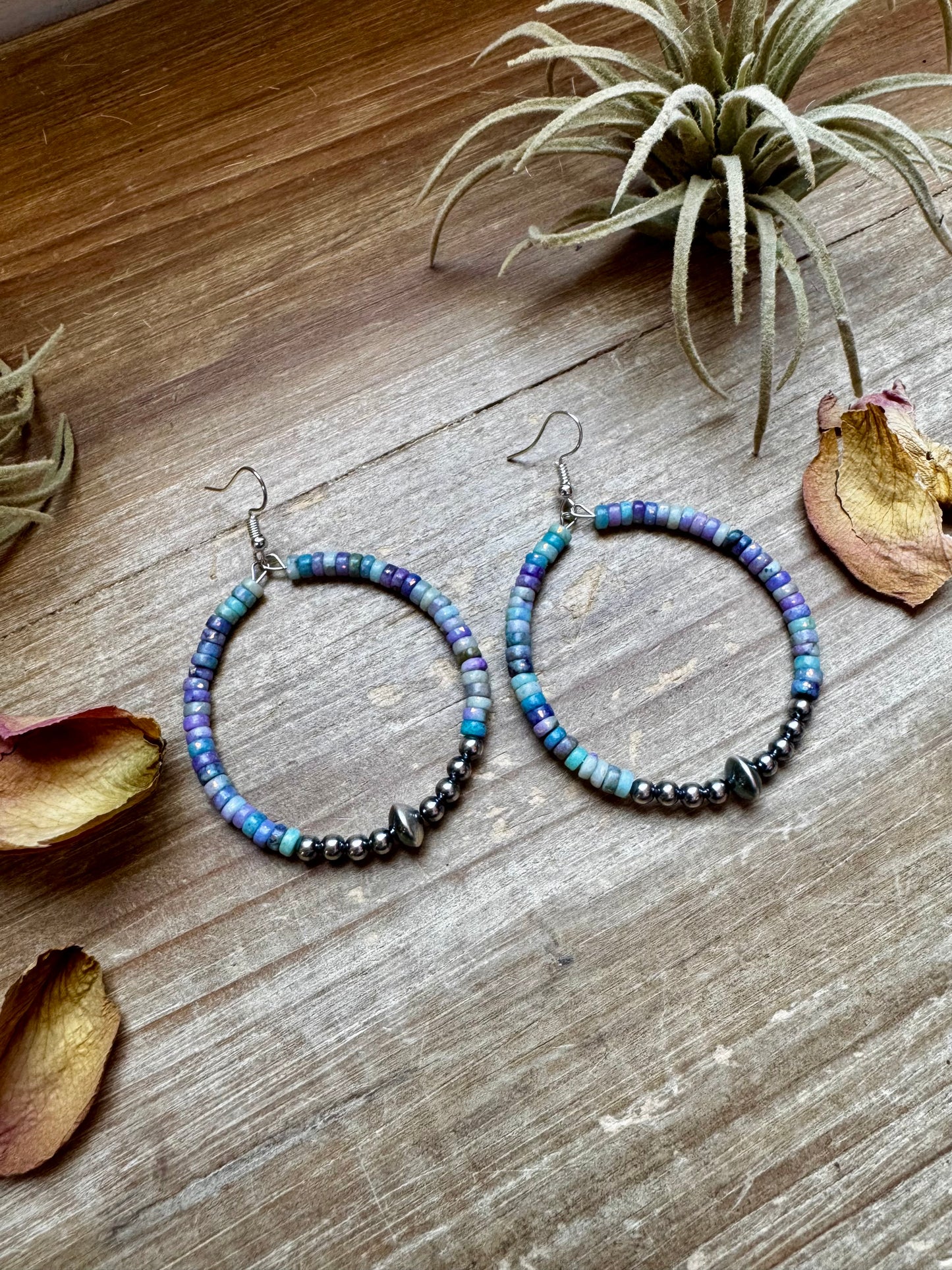 2-inch hoop earrings featuring 4mm sterling silver pearls, sterling silver saucer beads, and 2x4mm Purple Dolomite Heishi. Finished with silver-plated hooks. Every pair has slightly unique color variation. Handmade in the USA by The Bijoux FAB.