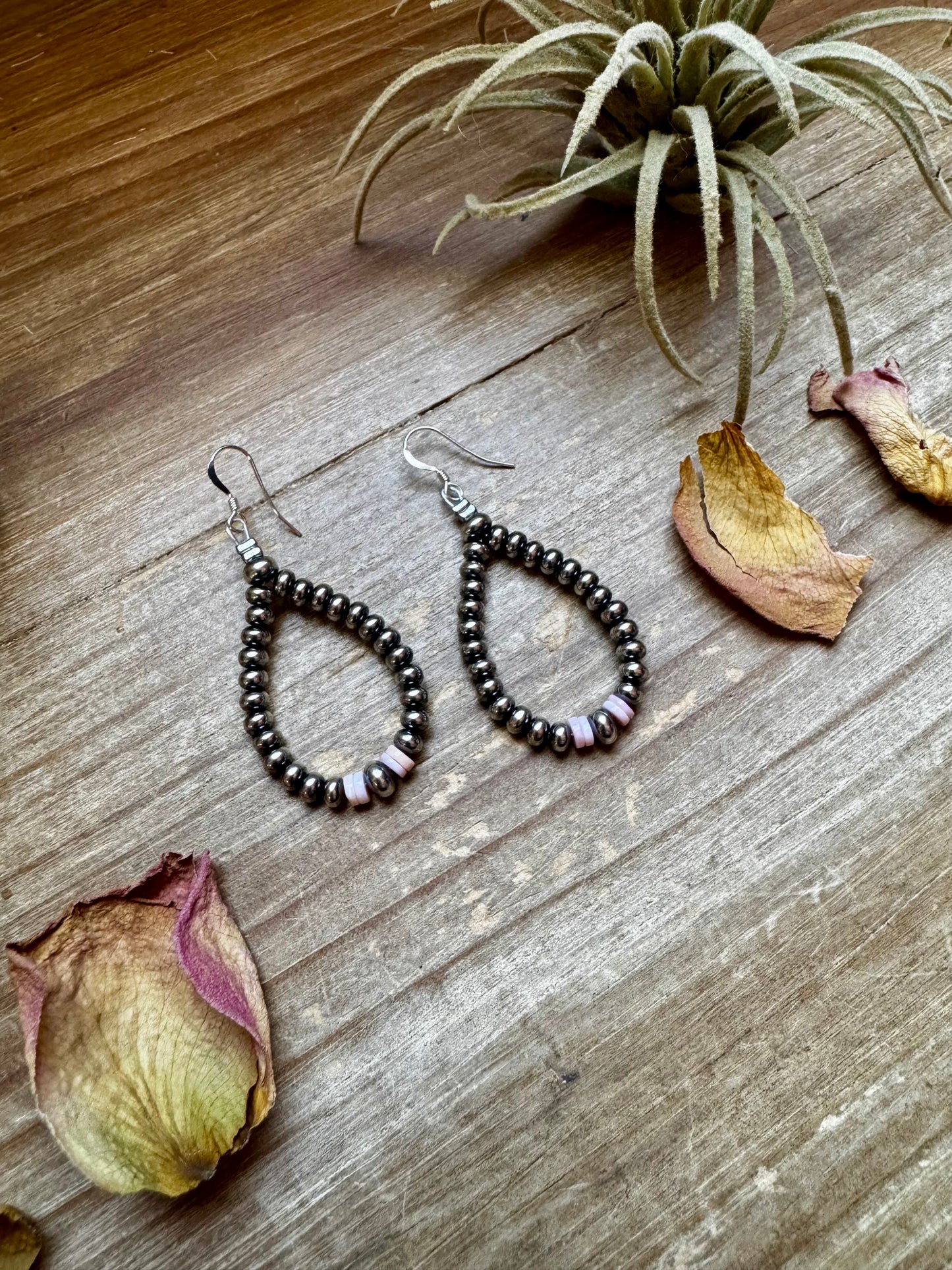 2.5-inch handmade dangle earrings featuring 4mm, 5mm, and 6mm saucer sterling silver pearls with Pink Conch Heishi accents. Includes .925 sterling silver hooks. Each pink conch shade is slightly unique. Lightweight and made in the USA by The Bijoux FAB.