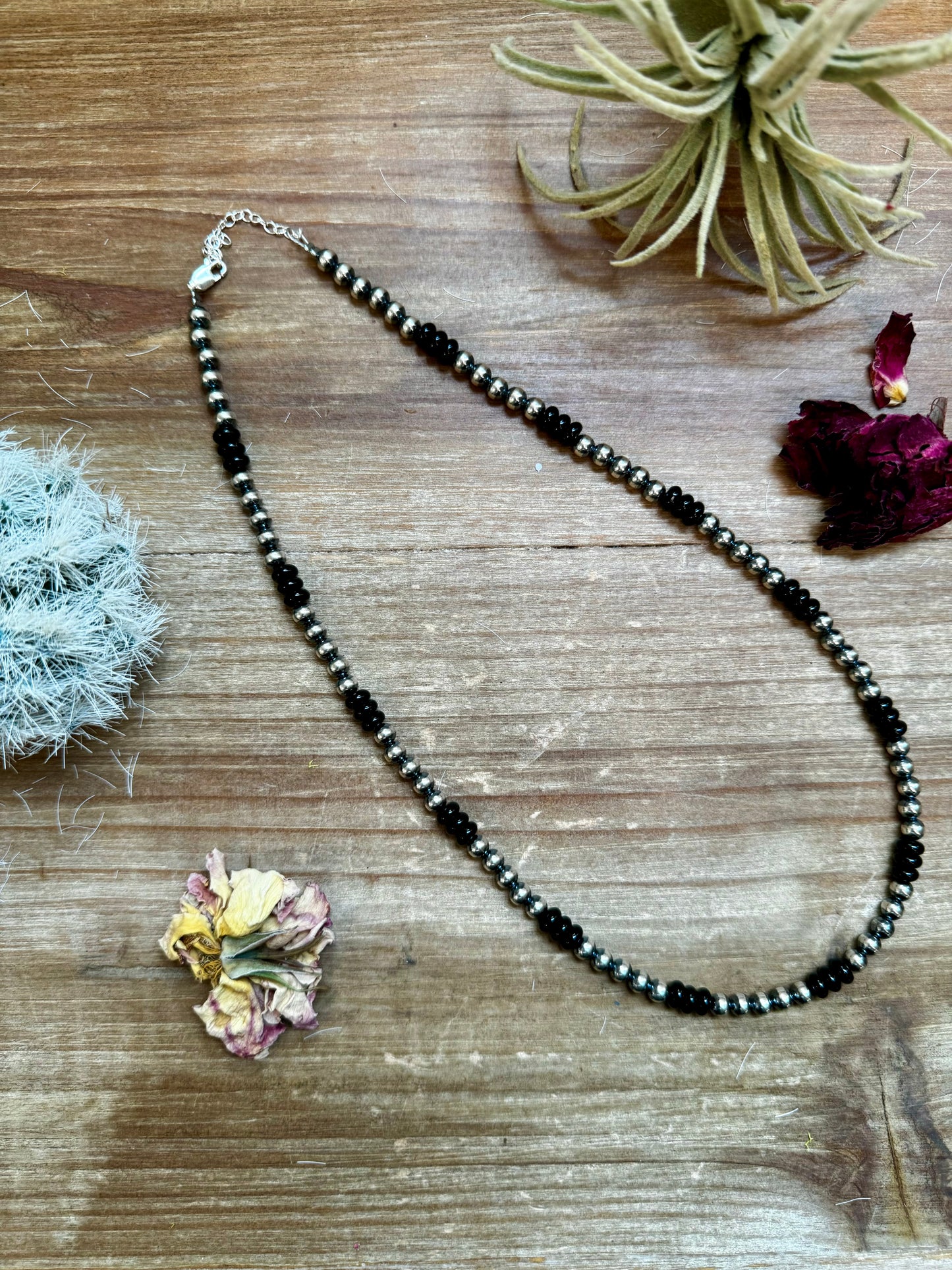 Handmade 18-inch necklace with 5mm sterling silver pearls and black onyx rondelle beads. Features a 3-inch sterling silver extender. Each piece has unique color variations. Made in the USA by The Bijoux FAB.