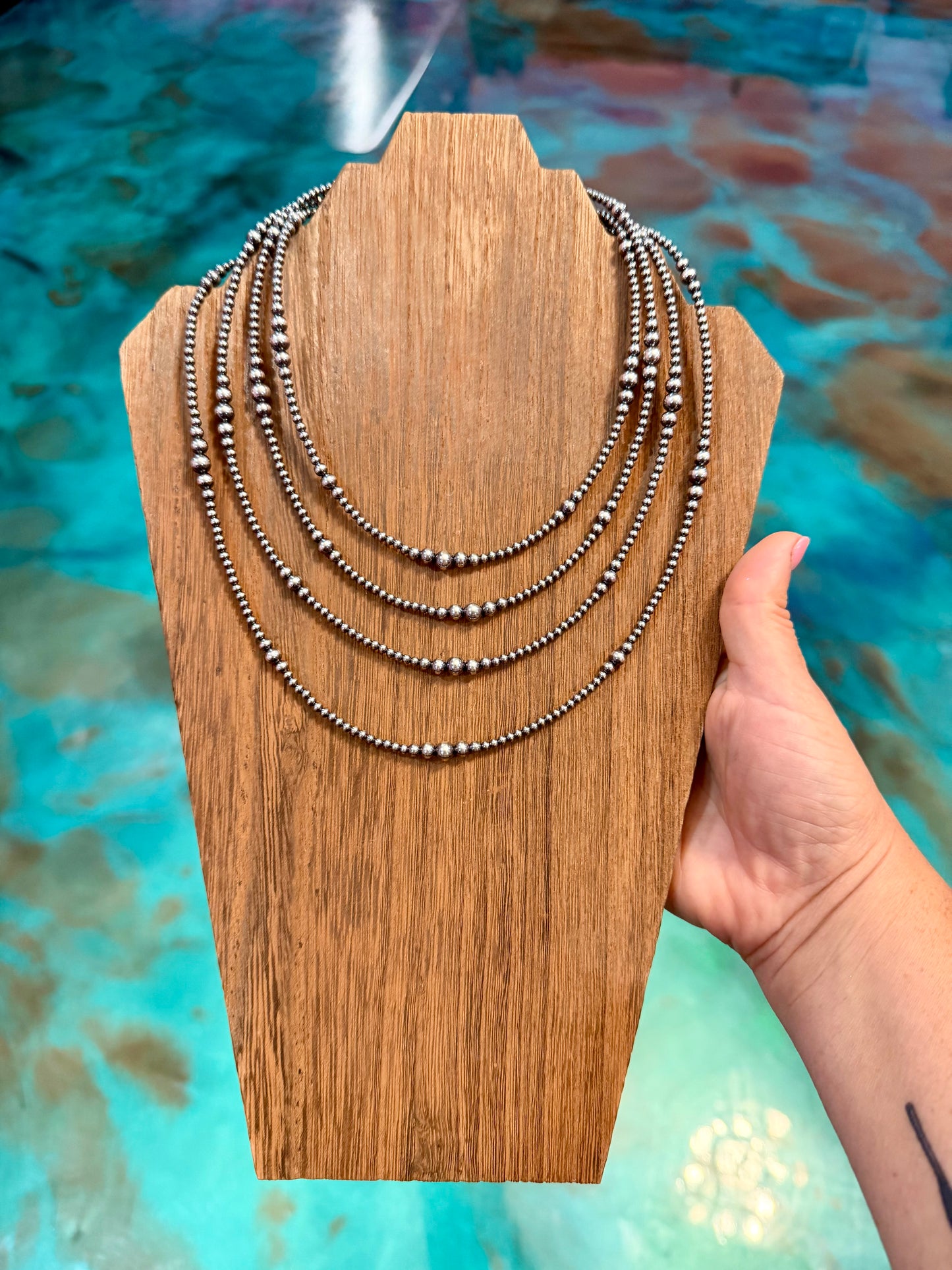 Four piece graduated sterling silver pearl layered necklace stack handmade by The Bijoux FAB