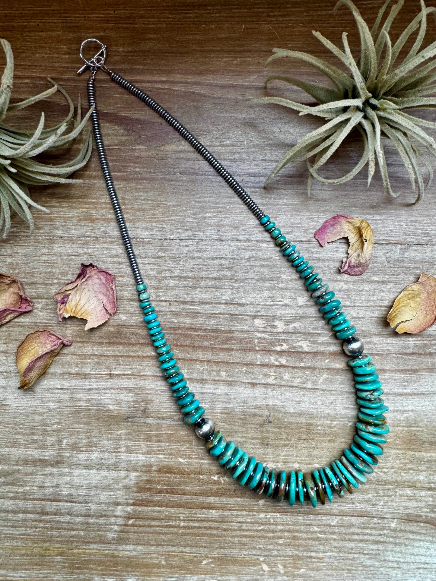 22-inch necklace featuring silver hematite beads, green turquoise stones, and 10mm sterling silver pearls. Non-tarnish hook closure. Each turquoise stone has a unique shape and color. Handmade in the USA by The Bijoux FAB.