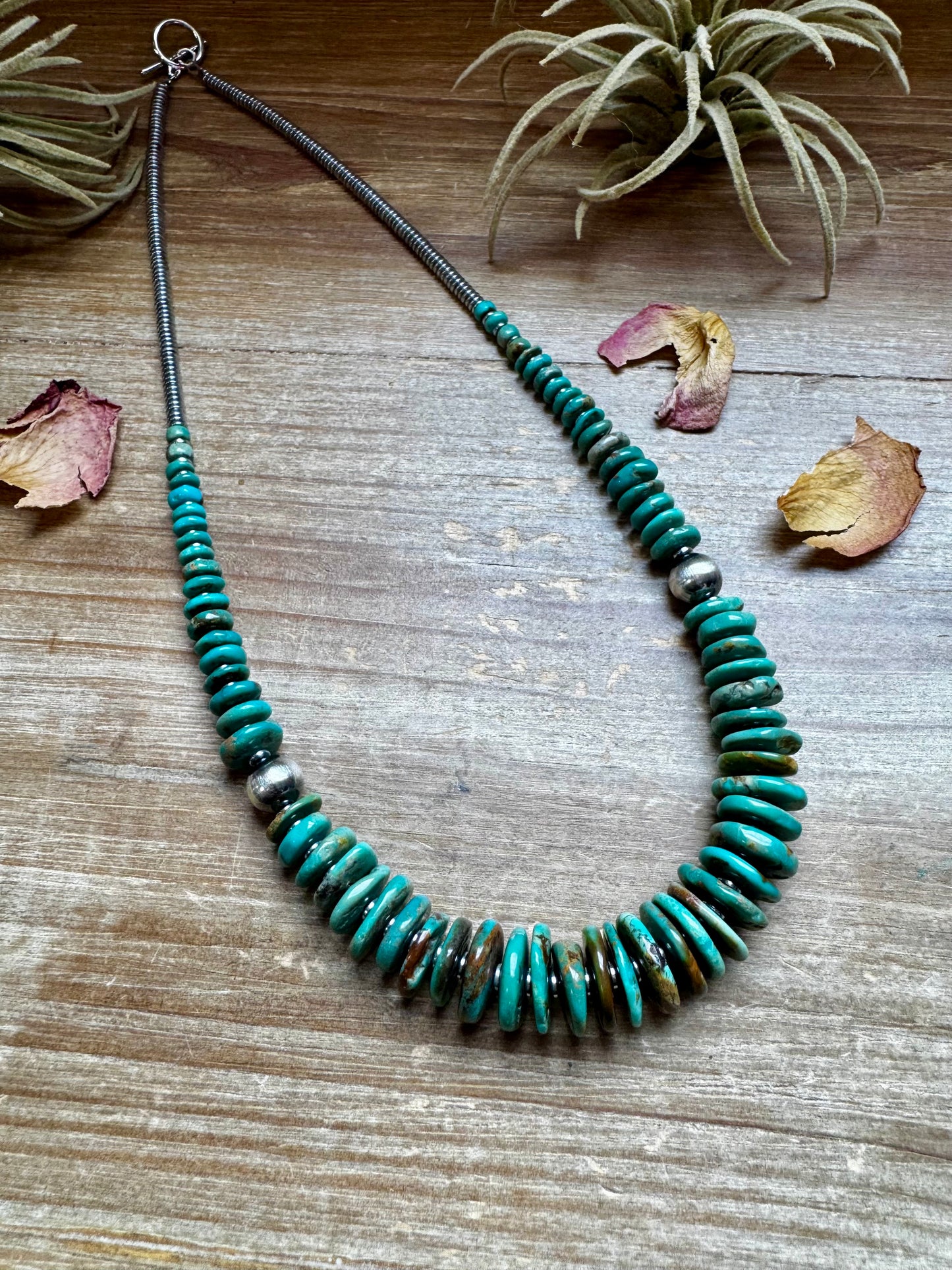 22-inch necklace featuring silver hematite beads, green turquoise stones, and 10mm sterling silver pearls. Non-tarnish hook closure. Each turquoise stone has a unique shape and color. Handmade in the USA by The Bijoux FAB.