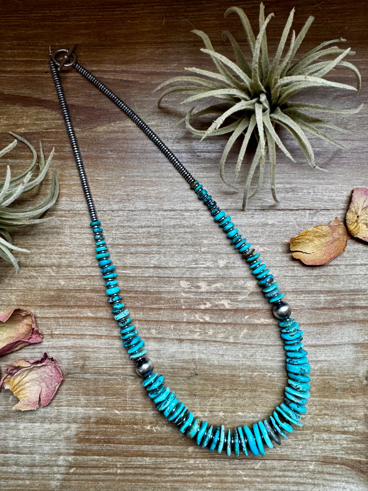 22-inch necklace featuring silver hematite beads, blue turquoise stones, and 10mm sterling silver pearls. Finished with a non-tarnish hook. Each turquoise varies in shape and color. Handmade in the USA by The Bijoux FAB.