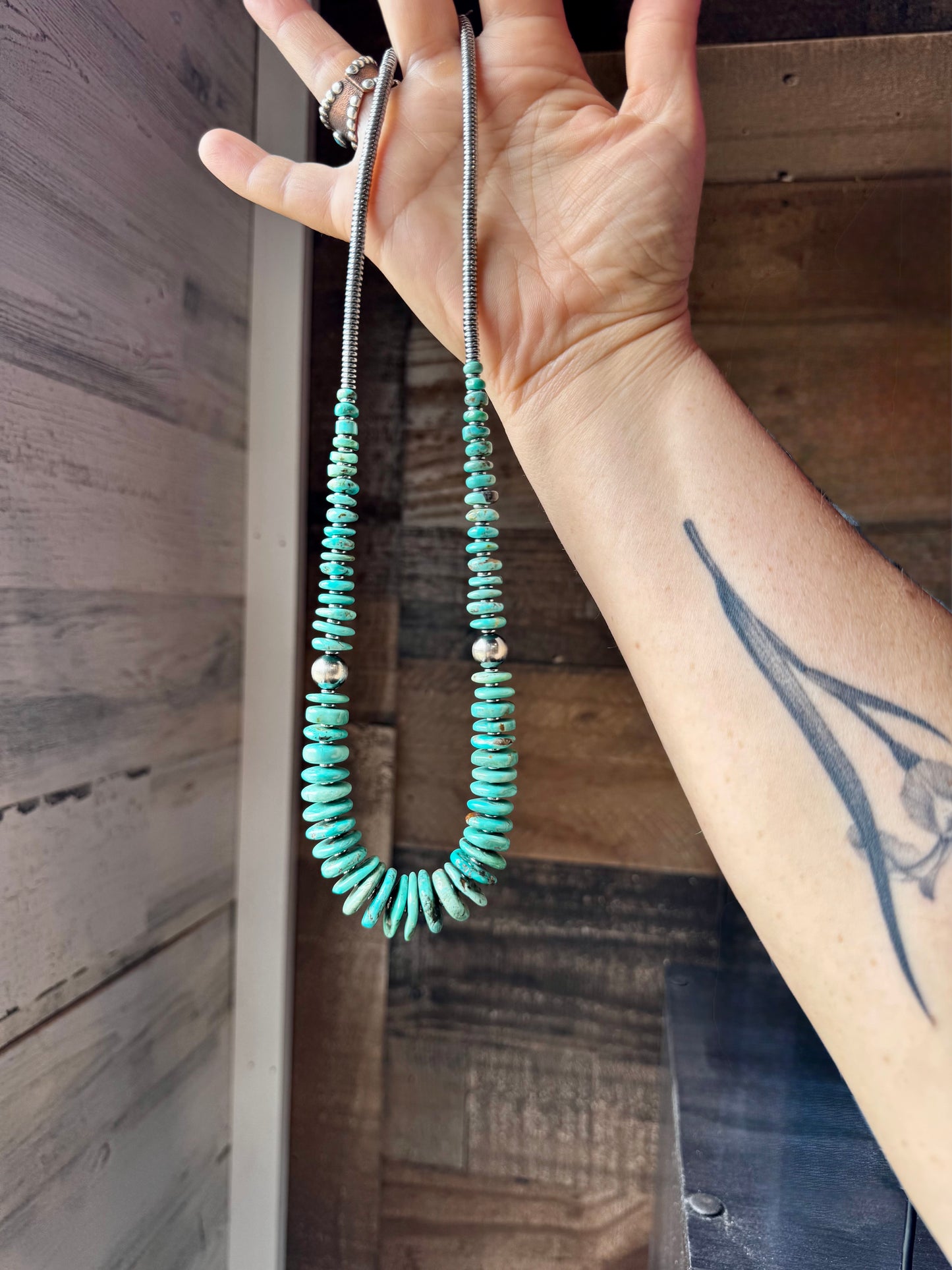 22-inch necklace featuring silver hematite beads, green-blue turquoise stones, and 10mm sterling silver pearls. Finished with a non-tarnish hook. Each turquoise stone has a unique shape and color. Handmade in the USA by The Bijoux FAB.