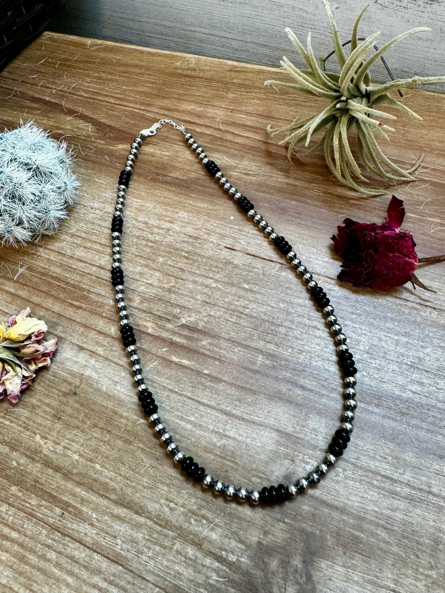 Handmade 18-inch necklace with 5mm sterling silver pearls and black onyx rondelle beads. Features a 3-inch sterling silver extender. Each piece has unique color variations. Made in the USA by The Bijoux FAB.