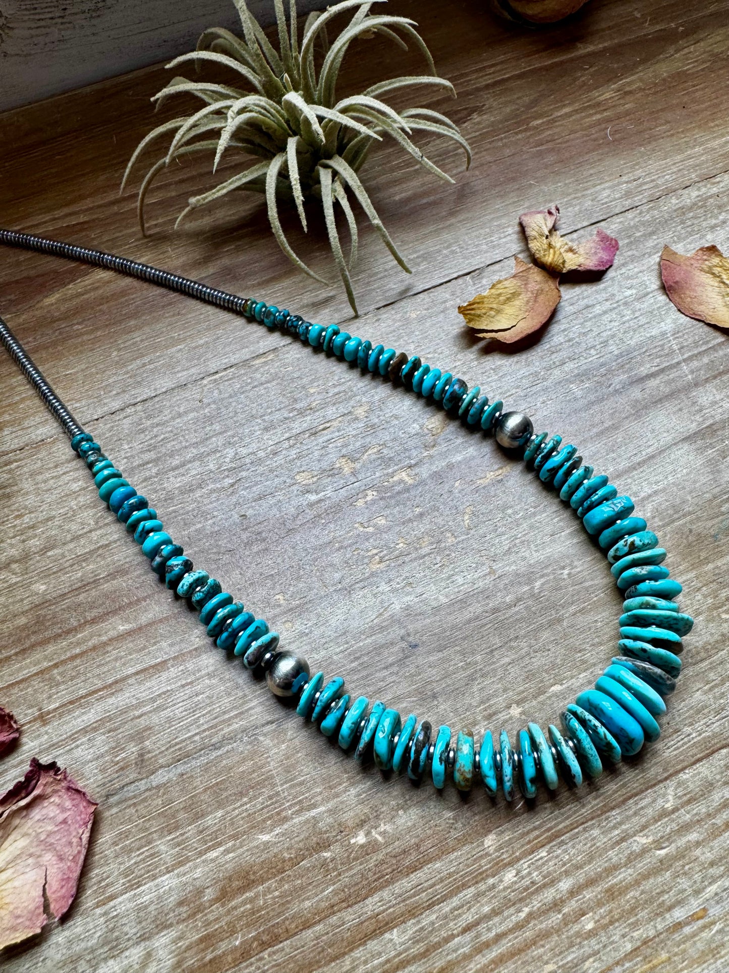 22-inch necklace featuring silver hematite beads, blue turquoise stones, and 10mm sterling silver pearls. Finished with a non-tarnish hook. Each turquoise varies in shape and color. Handmade in the USA by The Bijoux FAB.
