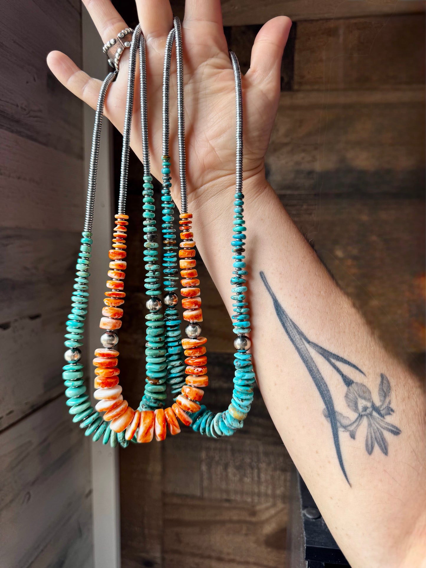 22-inch necklace featuring silver hematite beads, blue turquoise stones, and 10mm sterling silver pearls. Finished with a non-tarnish hook. Each turquoise varies in shape and color. Handmade in the USA by The Bijoux FAB.