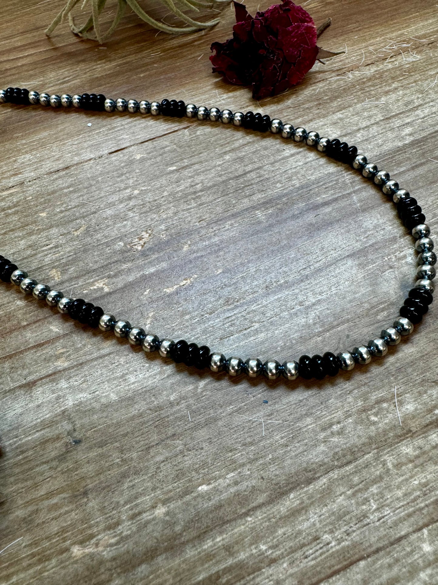 Handmade 18-inch necklace with 5mm sterling silver pearls and black onyx rondelle beads. Features a 3-inch sterling silver extender. Each piece has unique color variations. Made in the USA by The Bijoux FAB.