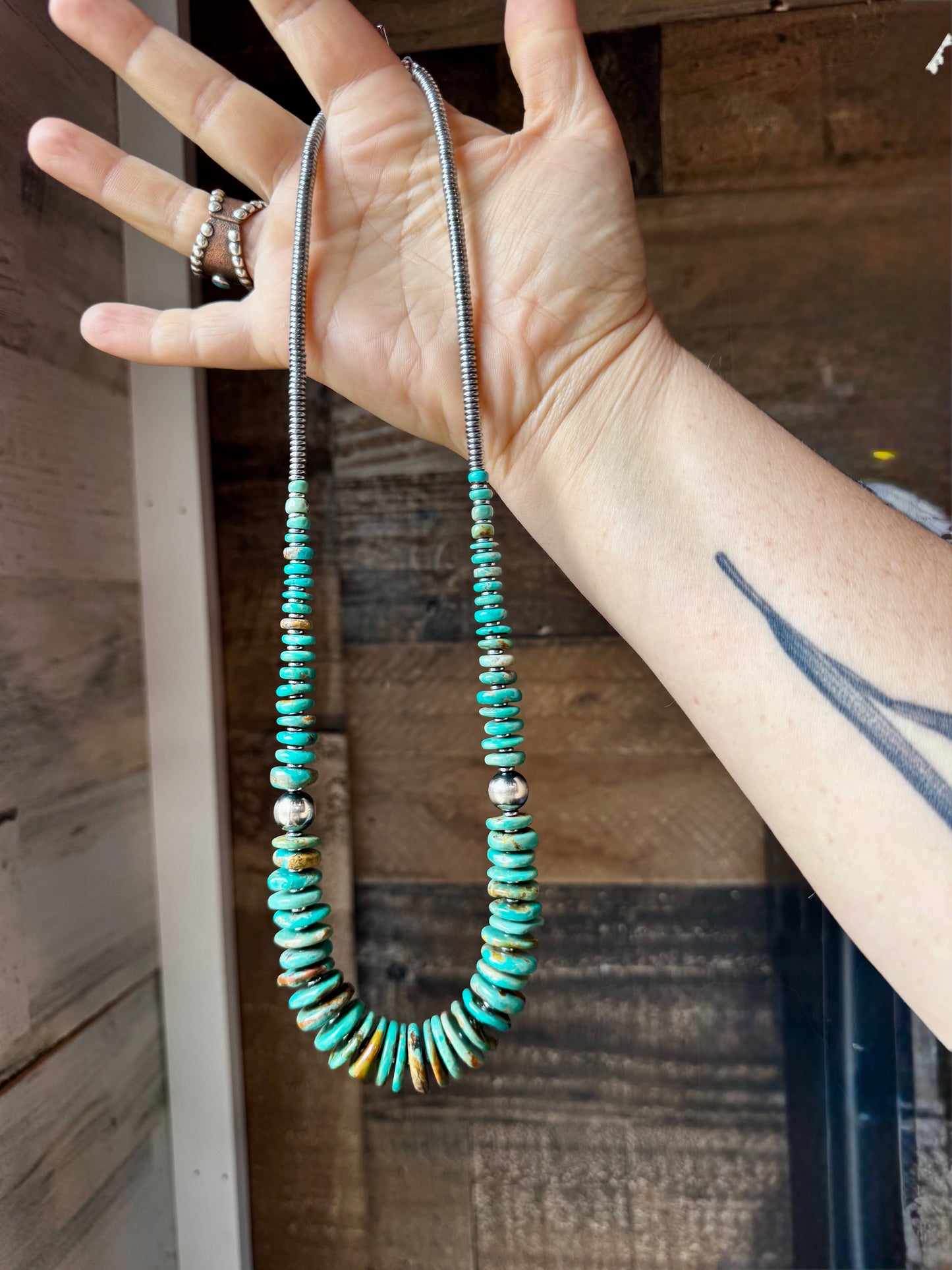 22-inch necklace featuring silver hematite beads, green turquoise stones, and 10mm sterling silver pearls. Non-tarnish hook closure. Each turquoise stone has a unique shape and color. Handmade in the USA by The Bijoux FAB.