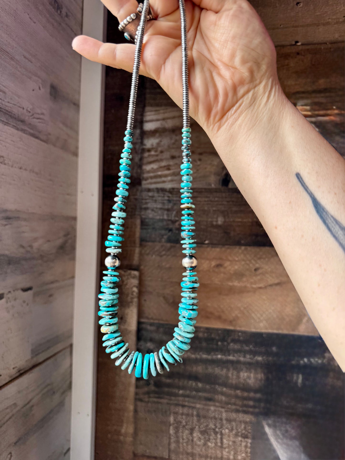 22-inch necklace featuring silver hematite beads, blue turquoise stones, and 10mm sterling silver pearls. Finished with a non-tarnish hook. Each turquoise varies in shape and color. Handmade in the USA by The Bijoux FAB.