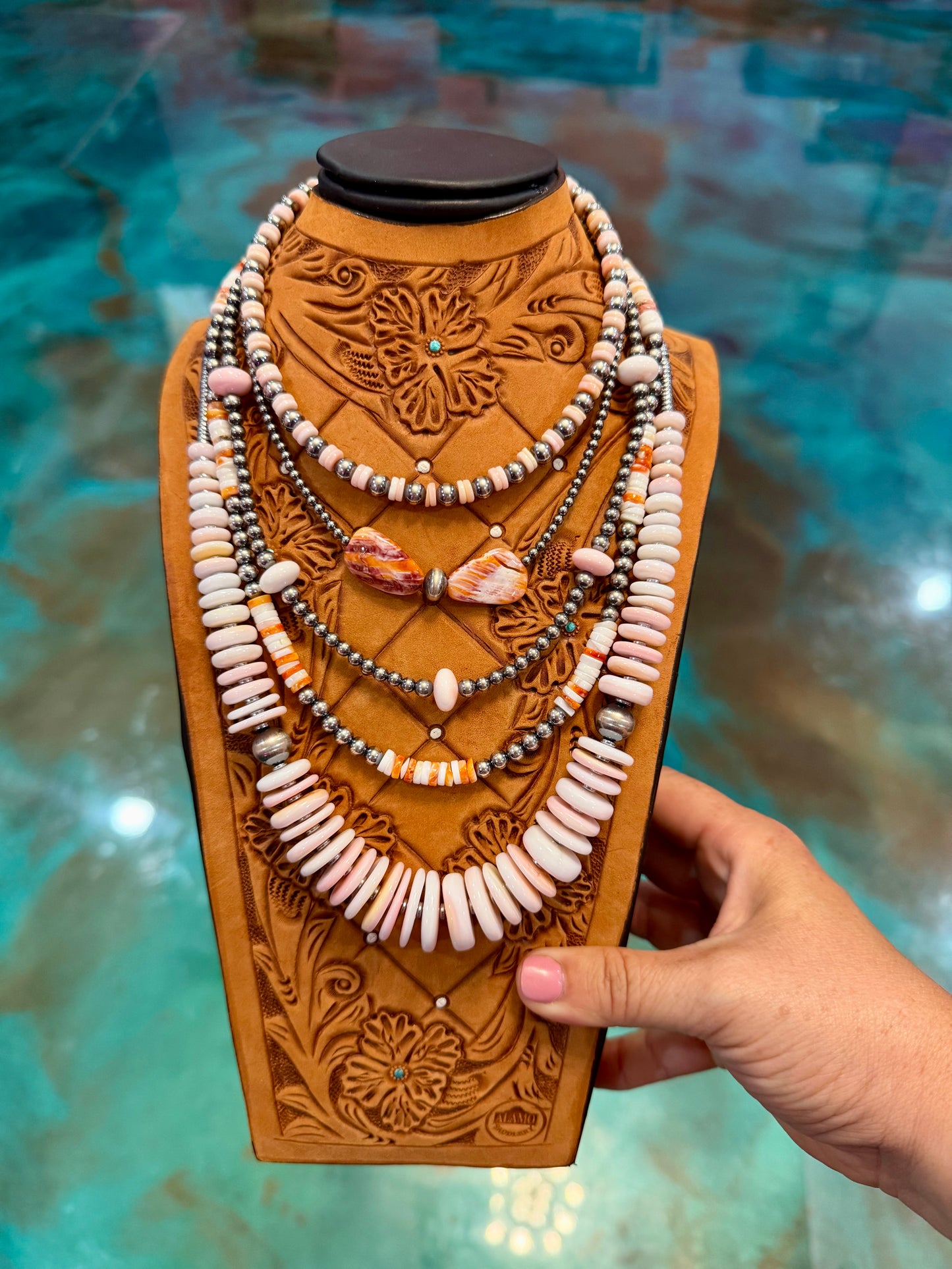 Layered sterling silver pearl necklace stack featuring pink conch shell, orange spiny oyster, hematite accents, and handmade western jewelry by The Bijoux FAB