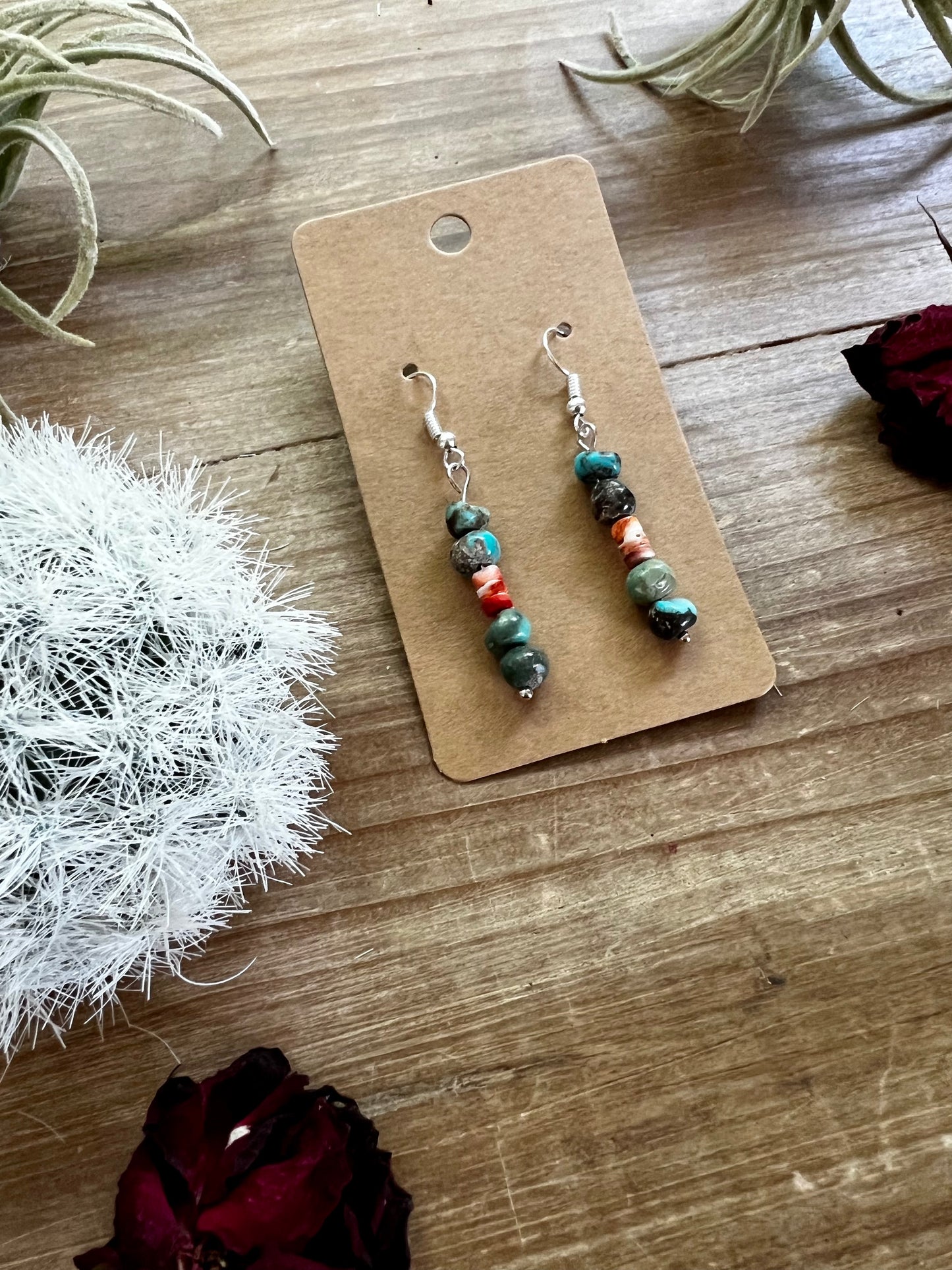 Red and blue earrings dangle real turquoise