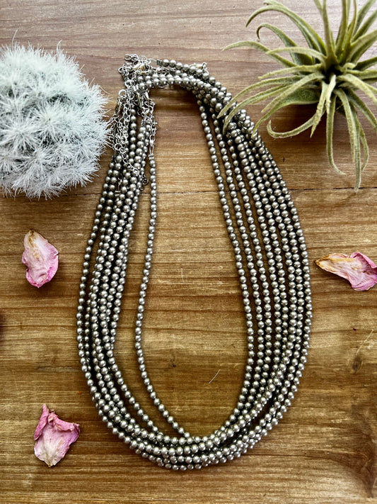 Close-up of an 18-inch necklace with 3-inch chain extender, made with 4mm silver-plated beads. Handmade in the USA by The Bijoux FAB. Sold separately. Ideal for layering or wearing solo.
