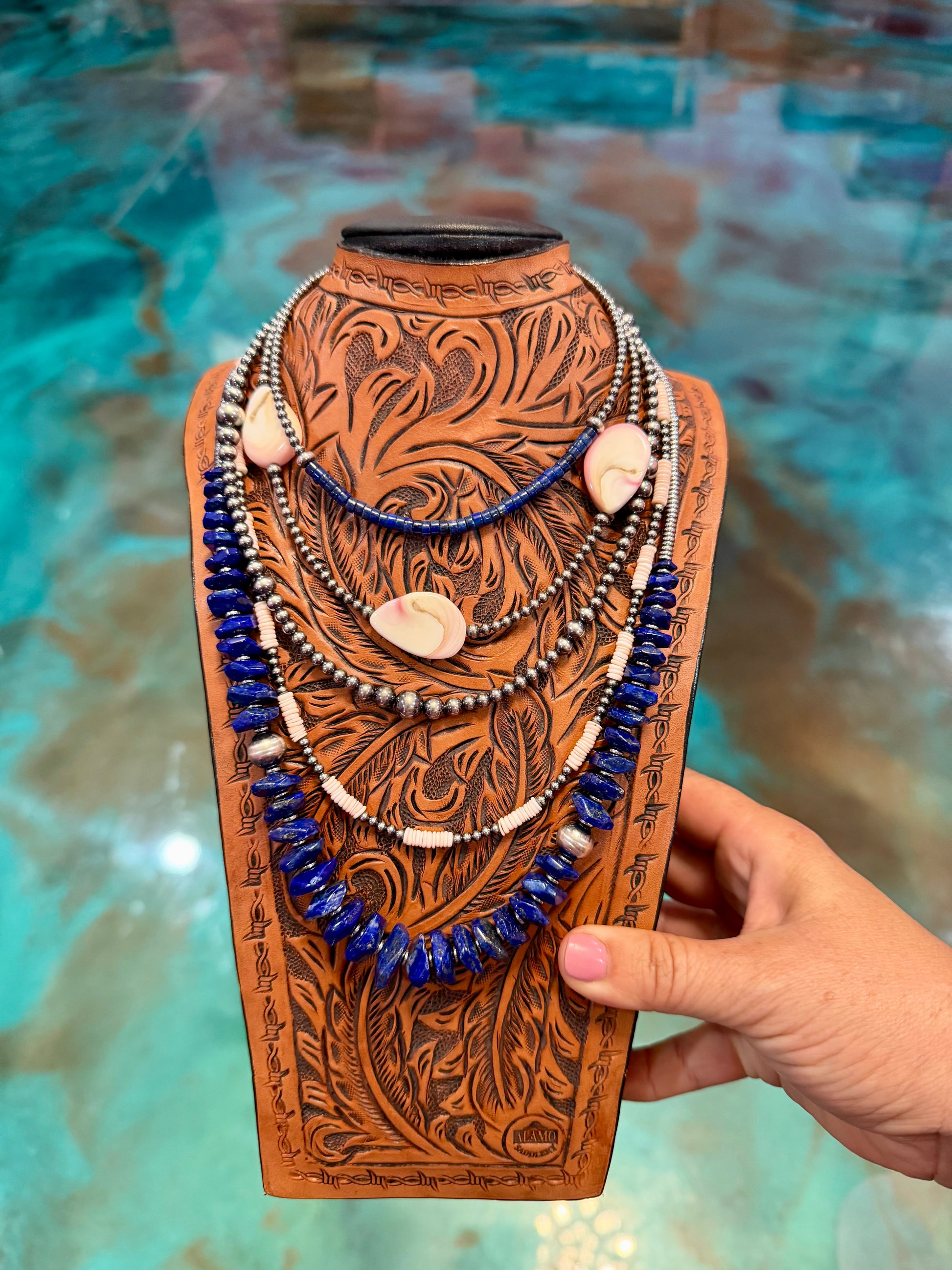 Layered sterling silver pearl necklace stack featuring lapis, pink conch shell, hematite accents, and handmade western jewelry by The Bijoux FAB