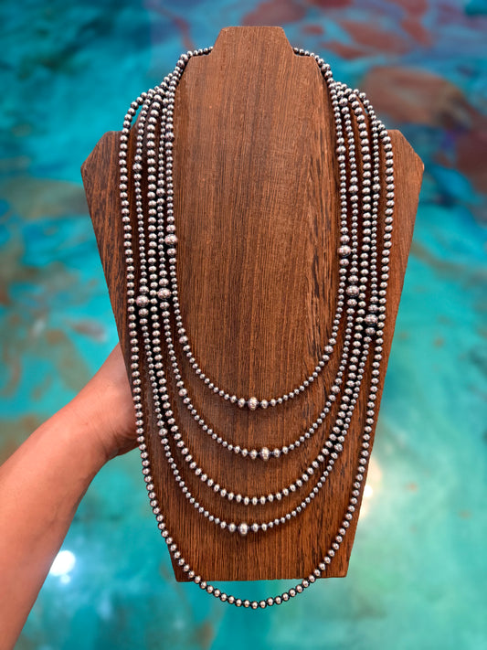 Long layered sterling silver pearl necklace stack handmade in the USA featuring graduated 4mm, 5mm, 6mm, and 8mm sterling silver pearls by The Bijoux FAB