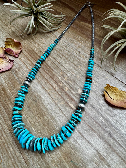 22-inch necklace featuring silver hematite beads, blue turquoise stones, and 10mm sterling silver pearls. Finished with a non-tarnish hook. Each turquoise varies in shape and color. Handmade in the USA by The Bijoux FAB.
