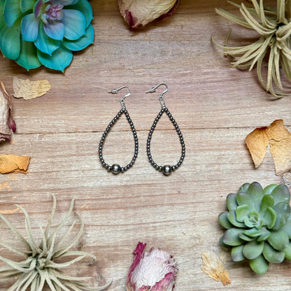 Sterling silver teardrop earrings featuring 3mm sterling silver beads, 4mm sterling silver accent beads, and a polished 8mm sterling silver center bead. Lightweight handcrafted design measuring approximately 3 inches long, made in the USA by The Bijoux FAB.