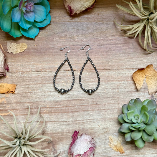 Sterling silver teardrop earrings featuring 3mm sterling silver beads, 4mm sterling silver accent beads, and a polished 8mm sterling silver center bead. Lightweight handcrafted design measuring approximately 3 inches long, made in the USA by The Bijoux FAB.
