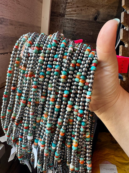 Handmade 18-inch sterling silver pearl necklace with turquoise and spiny oyster beads, shown with extender for layering