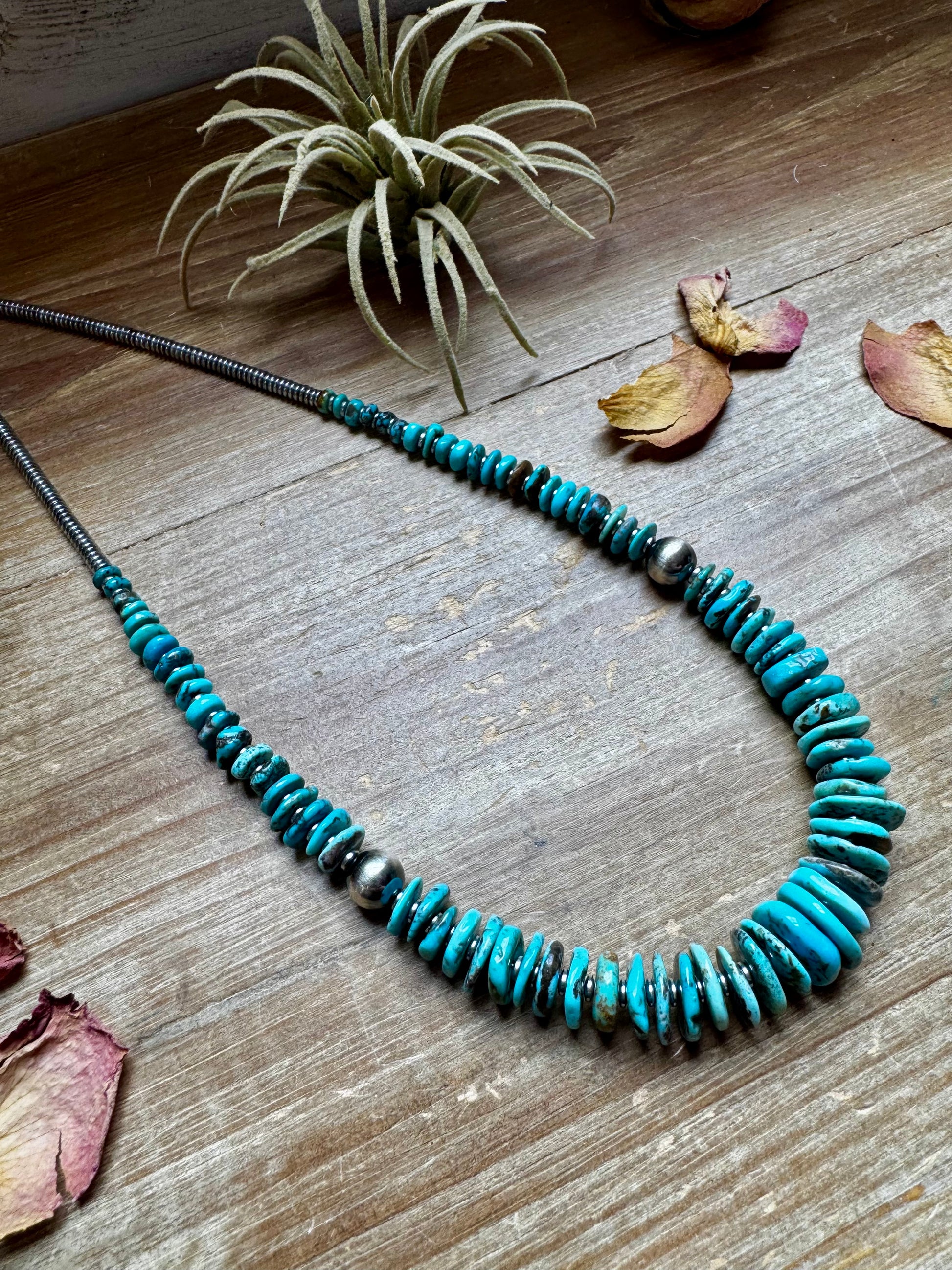 22-inch necklace featuring silver hematite beads, blue turquoise stones, and 10mm sterling silver pearls. Finished with a non-tarnish hook. Each turquoise varies in shape and color. Handmade in the USA by The Bijoux FAB.