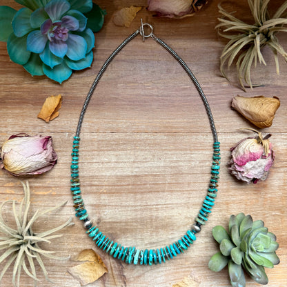 23 inch graduated turquoise necklace with blue and green tones, hematite saucer spacers, and 10mm sterling silver pearls handmade in the USA