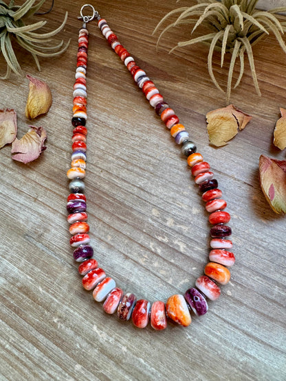 22-inch handmade necklace with vibrant spiny oyster beads in orange, red, purple, and purple wampum shell, spaced with hematite and two large sterling silver pearls
