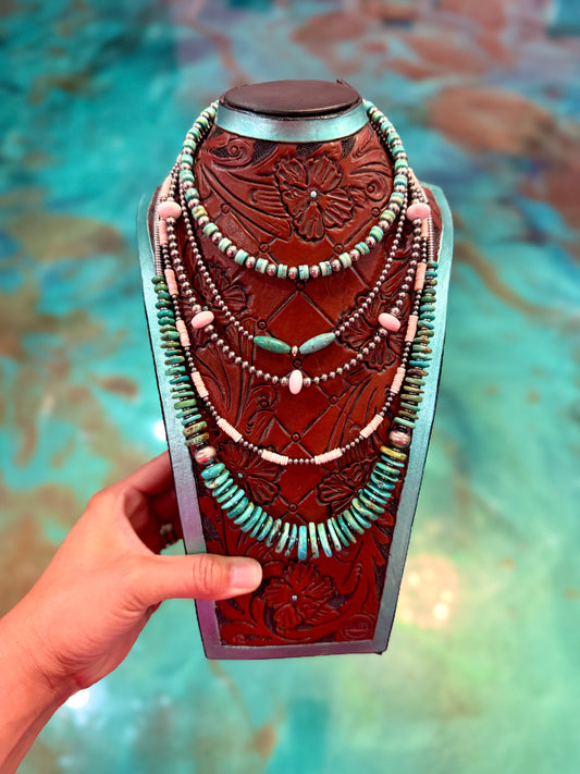 Five piece western necklace stack featuring turquoise, pink conch shell, hematite, heishi beads, and sterling silver pearls handmade by The Bijoux FAB