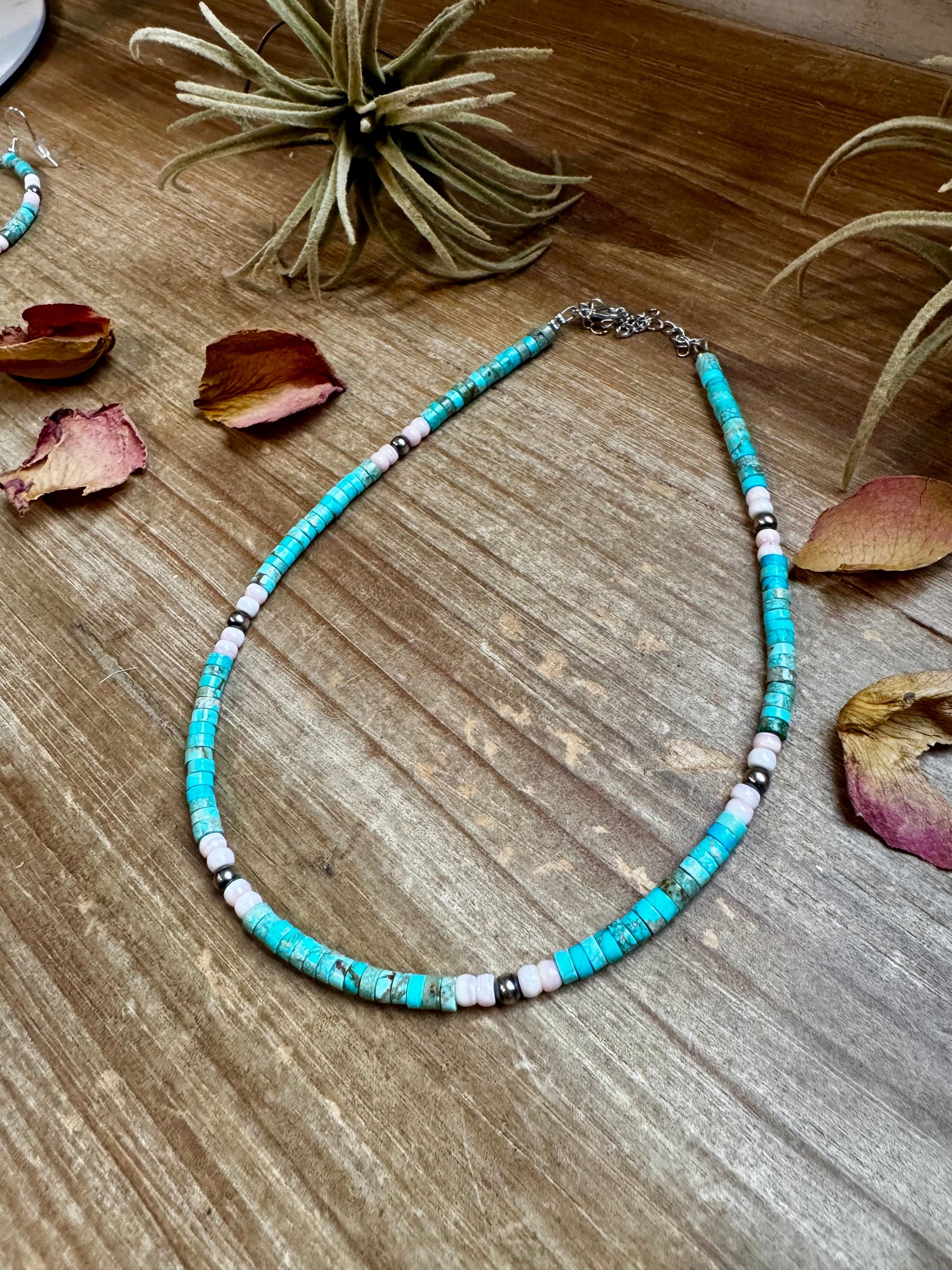 Handmade 14-inch choker with 3-inch extender, featuring 4mm turquoise variscite, pink conch, and sterling silver beads. Finished with silver-plated findings. Made in North Texas and exclusive to The Bijoux FAB. Matching earrings available.
