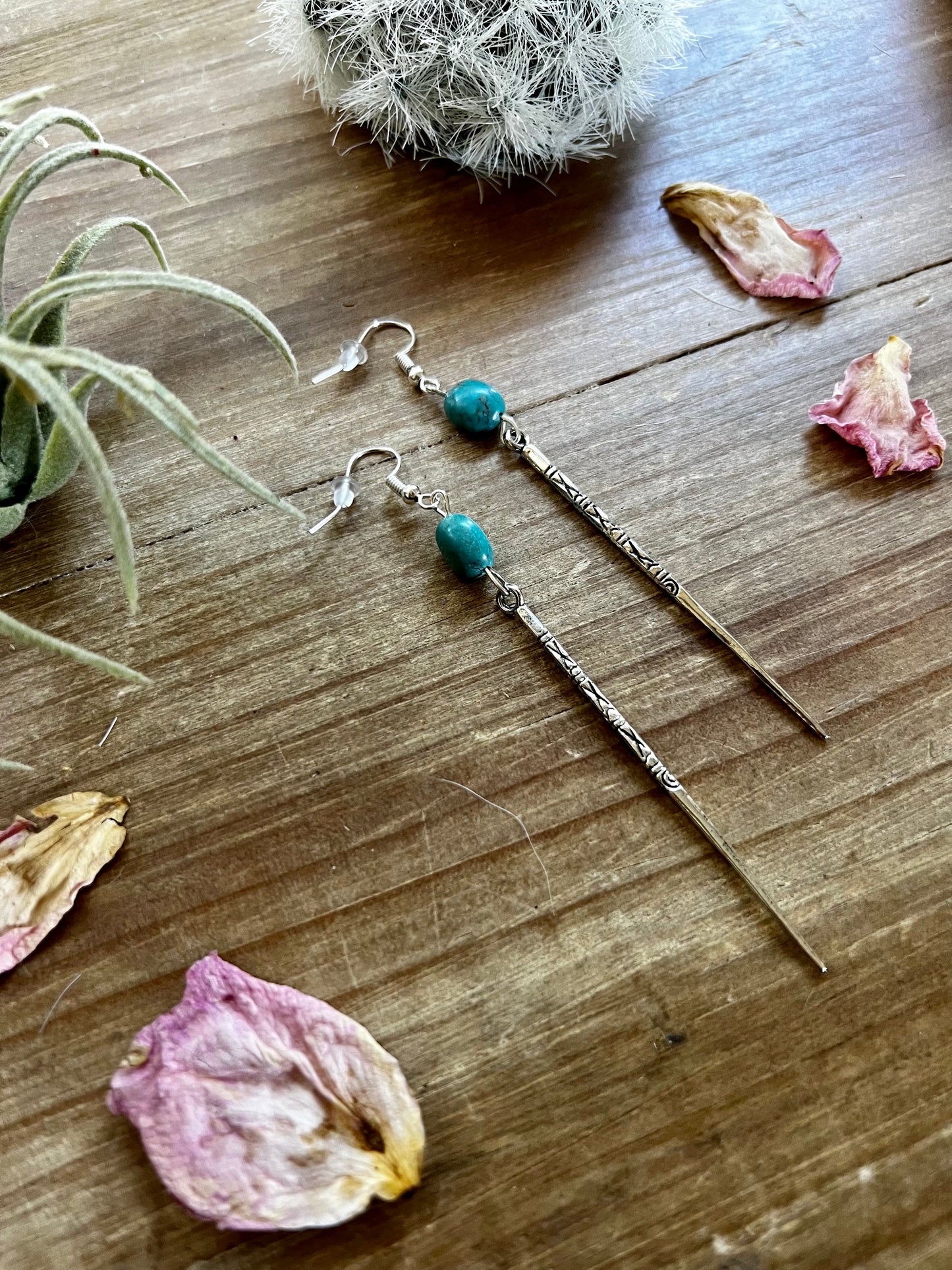 Earrings dangle with turquoise